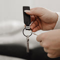 Orbitkey LoopZwart│Sleutelhange Leer│art. PLK1-BLK-101│met handen die sleutel toevoegen