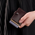 Secrid Miniwallet Original│art. M-CHOCOLATE│in hand met uitgeschoven pasjes