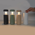 Sompex Lubao Oplaadbare Tafellamp Sand│art. 78623│vier kleuren op rij met hand die één lamp uitzet