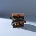 Secrid Miniwallet Perforated│pasjeshouder│art. MPF-BLACK│groep diverse kleuren leersoort op stapel
