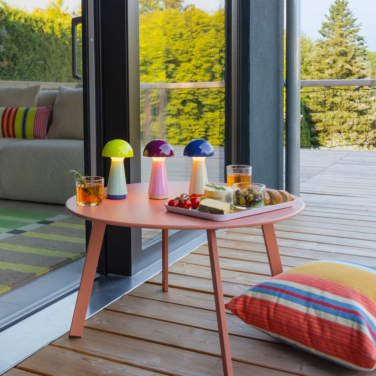 Remember Bobbi Rechargeable LED Table Lamp | in yellow, blue and berry on a round table on the terrace