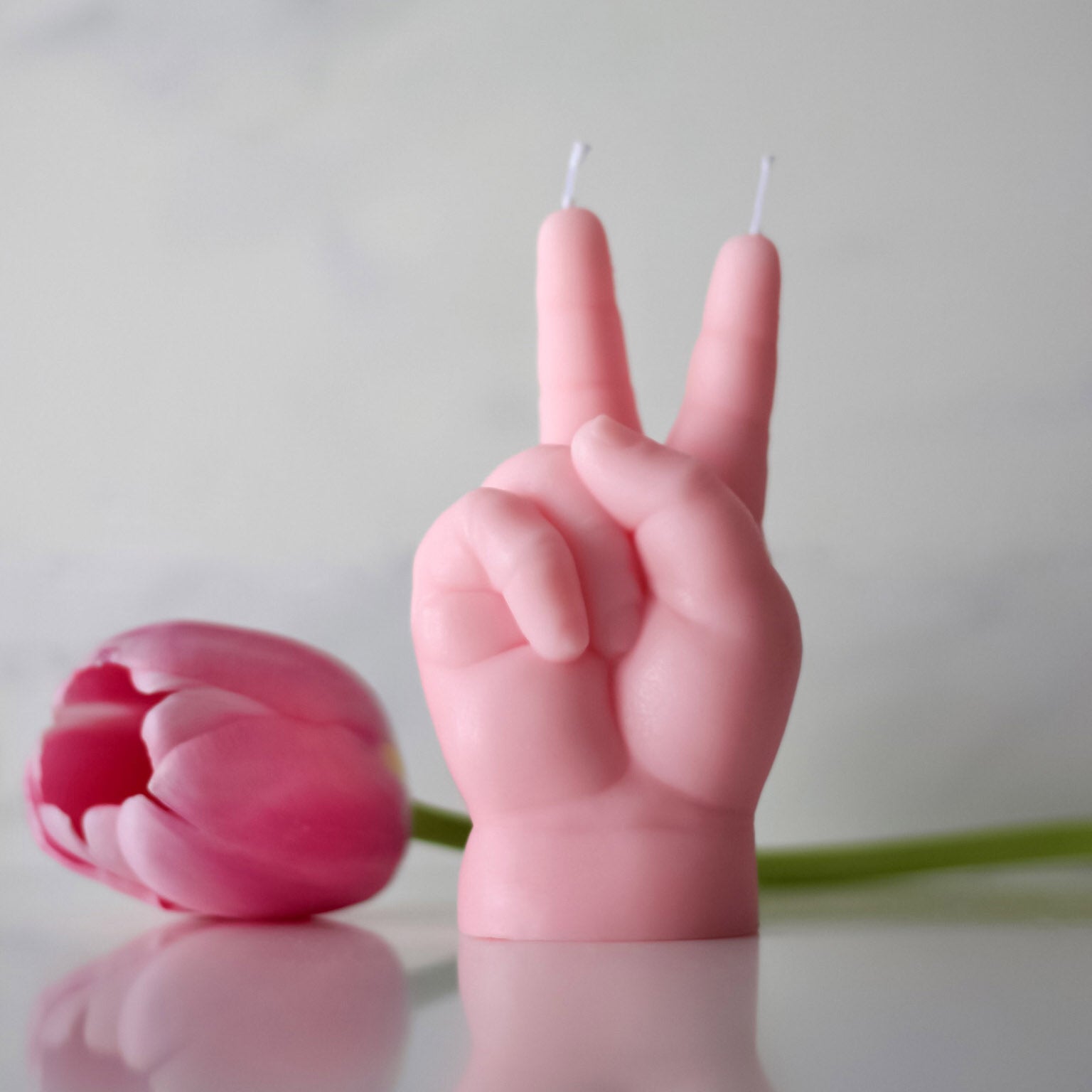 Candlehand Peace Kaars Baby Roze│art. BB-PEA-PINK│vooraanzicht naast roze tulp