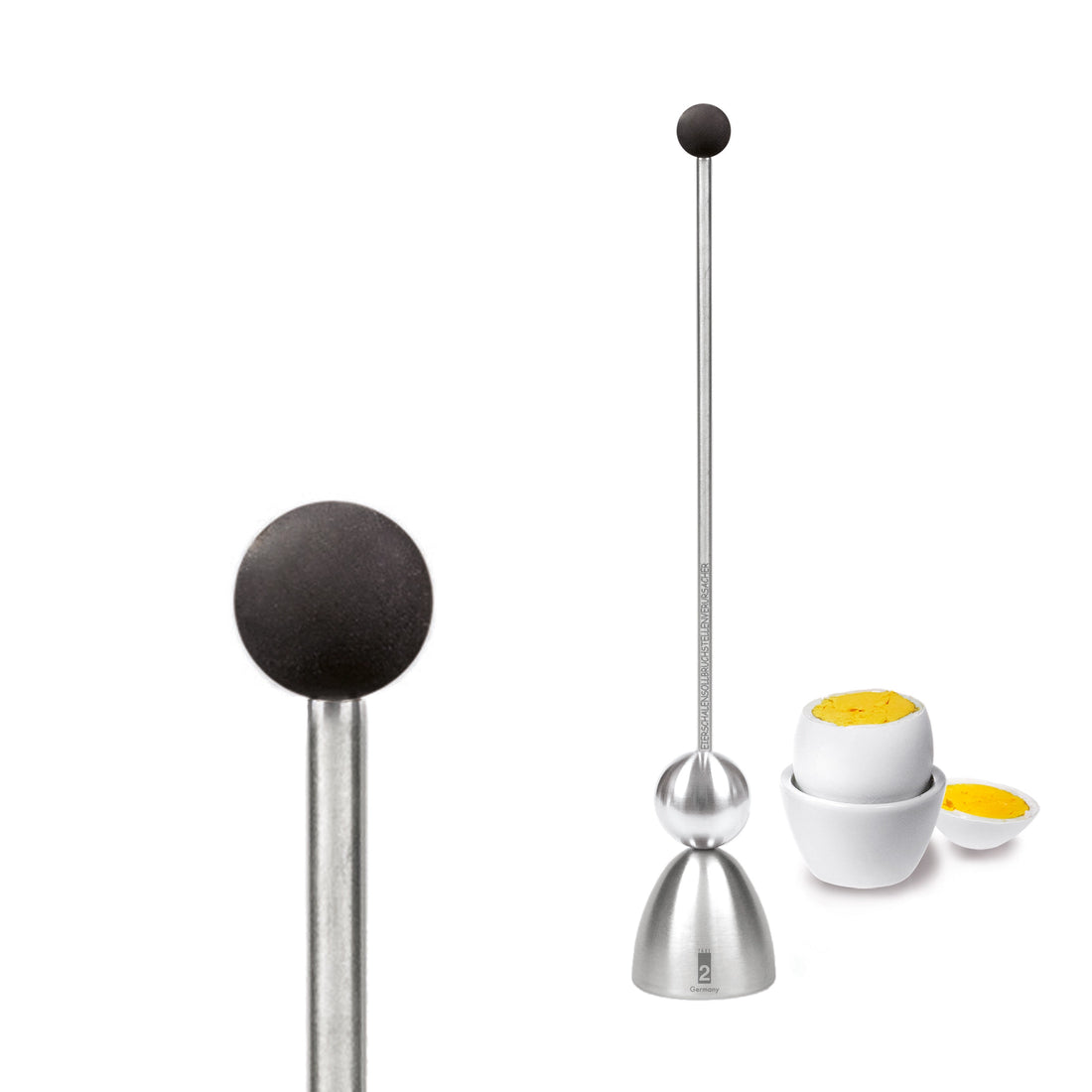 Clack egg topper with a black silicone ball, close up beside a boiled egg.