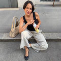 Insulated Bottle 350 ml Maple Yellow (yellow) - woman sitting on a step unscrewing the cap from the bottle