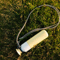 Insulated Bottle 350 ml Maple Yellow (yellow) - seen from above, lying in the grass on a cord