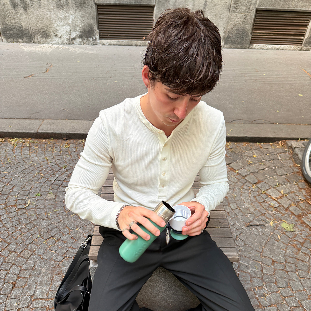 Insulated Bottle 350 ml Pine Green (green) - man pouring water into the cup on the street