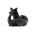 Gluckigluck salt and pepper shakers shaped like fish, in black, standing and lying down.