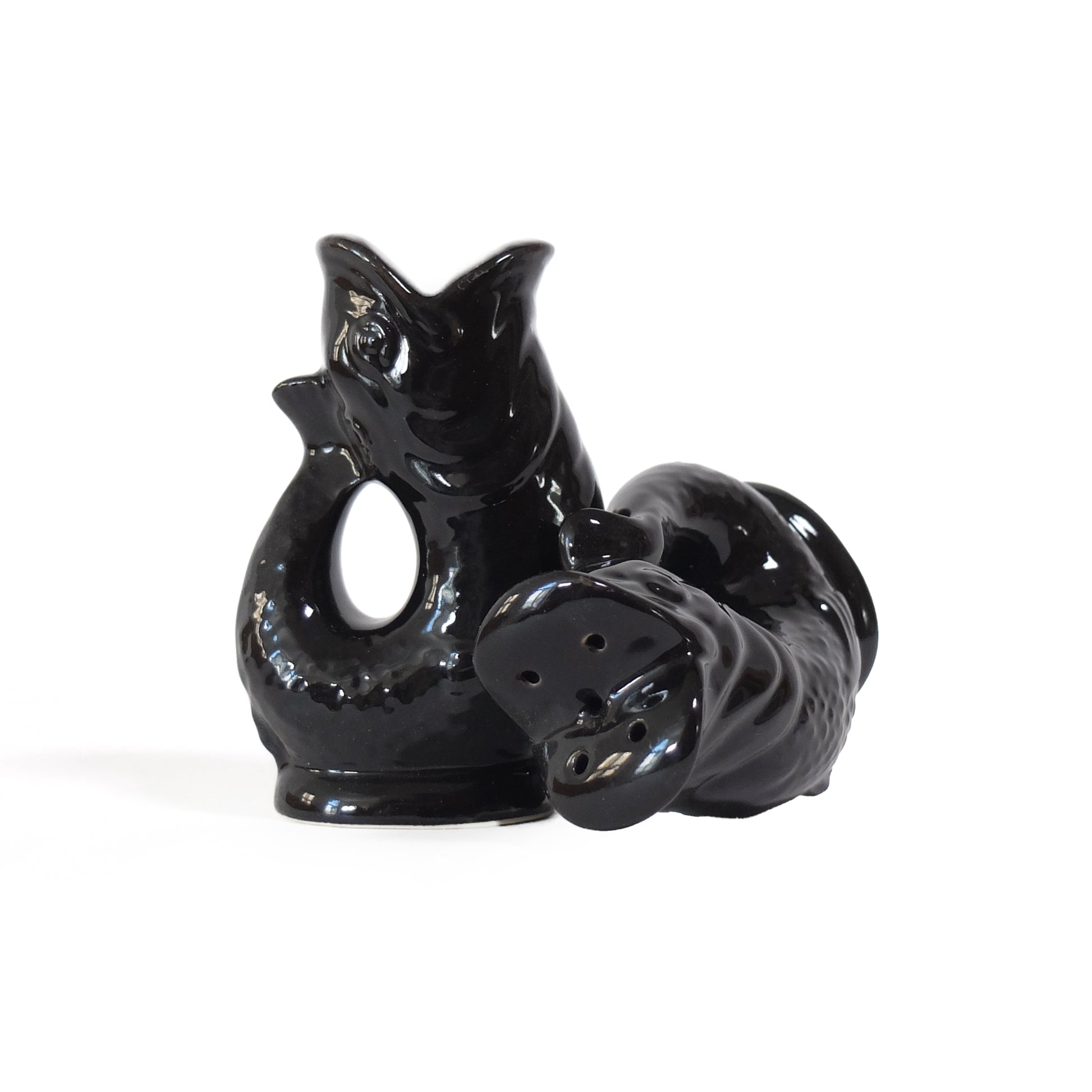 Gluckigluck salt and pepper shakers shaped like fish, in black, standing and lying down.