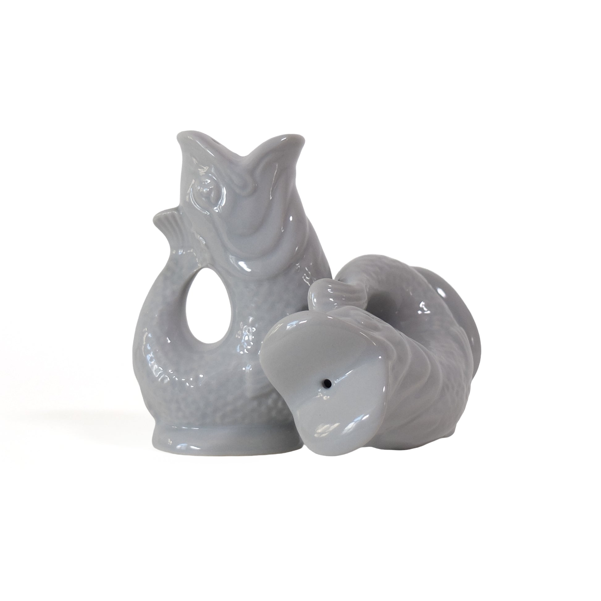 Gluckigluck salt and pepper shakers shaped like fish, in Oyster pearl grey, standing and lying down.