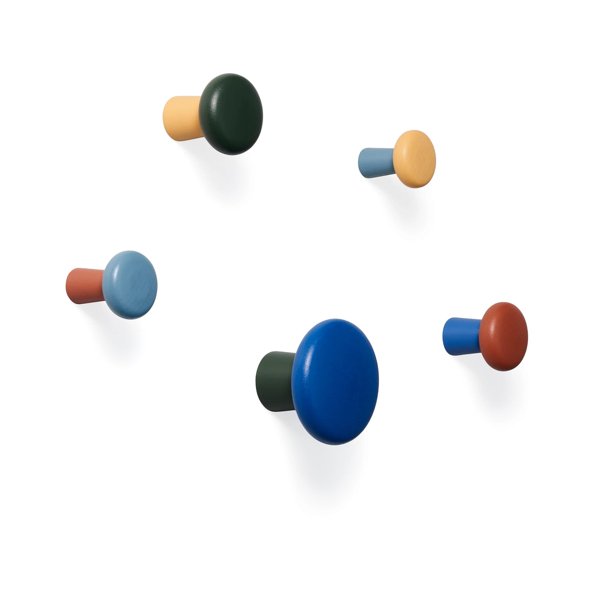 The five Harbor wall hooks by Areaware on a white wall.