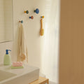 Harbor wall hooks on the wall in a bathroom.
