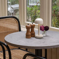Humble Two Oplaadbare Tafellamp Ivory│op ronde tafel met licht aan naast peper en zout stel│art. HUMTL00218