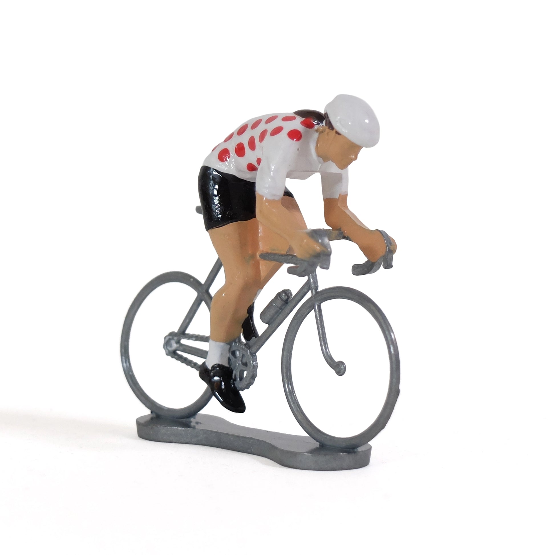 Miniature female cyclist in the polka dot jersey by Bernard & Eddy, at an angle from the front