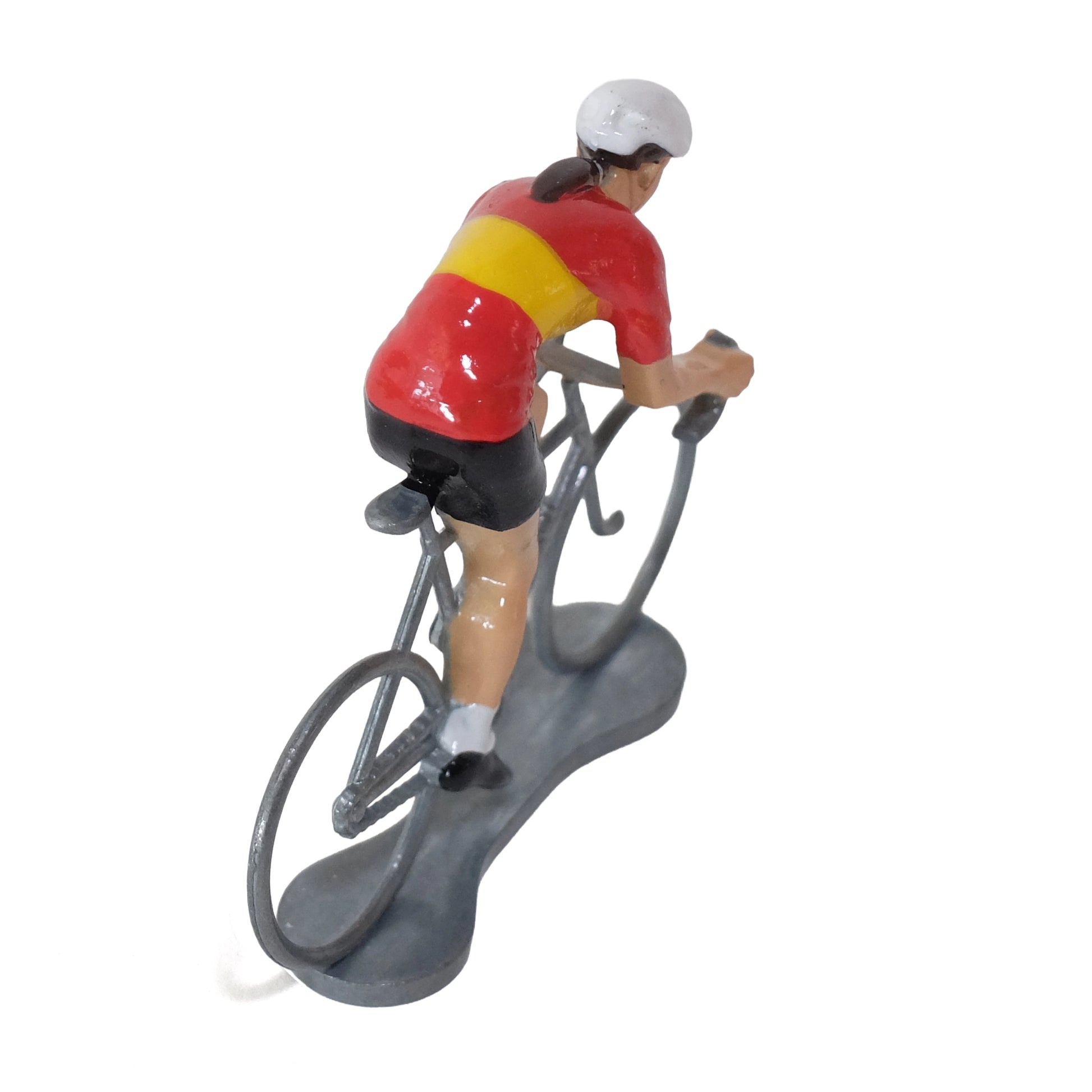 Miniature female cyclist in the Spanish champion's jersey by Bernard & Eddy, seen from behind