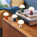 Lexon Mina Small Oranje│Oplaadbare LED-Lamp│art. LH60O1│diverse kleuren op houten tafeltje en boeken