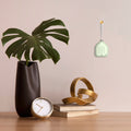 Relaxound Lily Bells Mossling│art. 11RLB0105001│tegen wand naast plant en accessoires op tafel