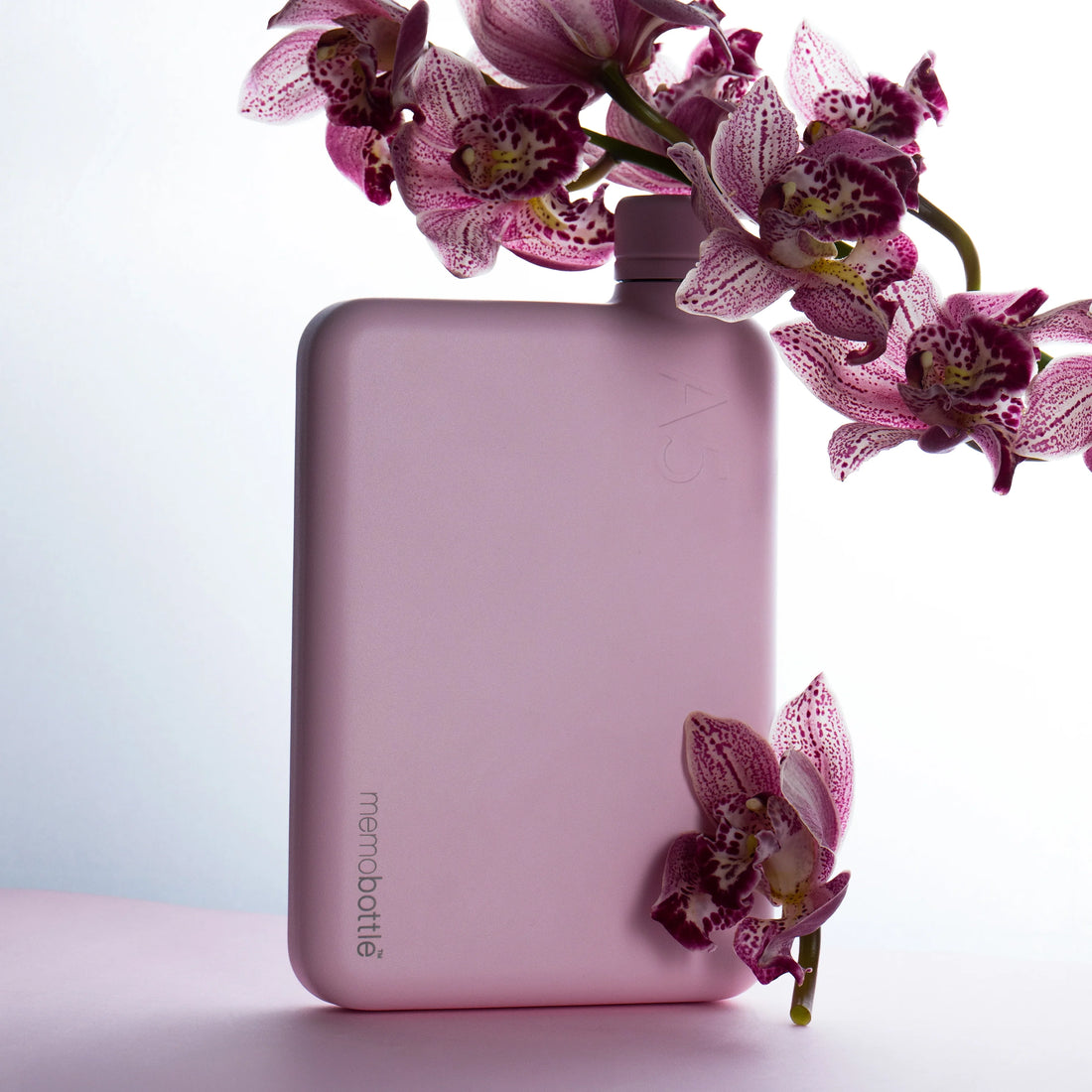 Memobottle A6 flat stainless steel water bottle in pink, front view on a white background.