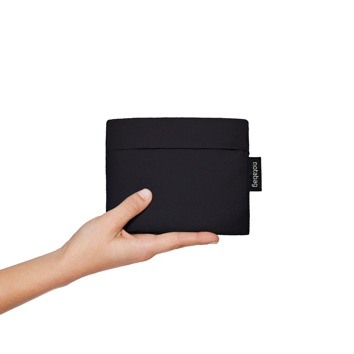 Black Notabag folded up in the matching pouch