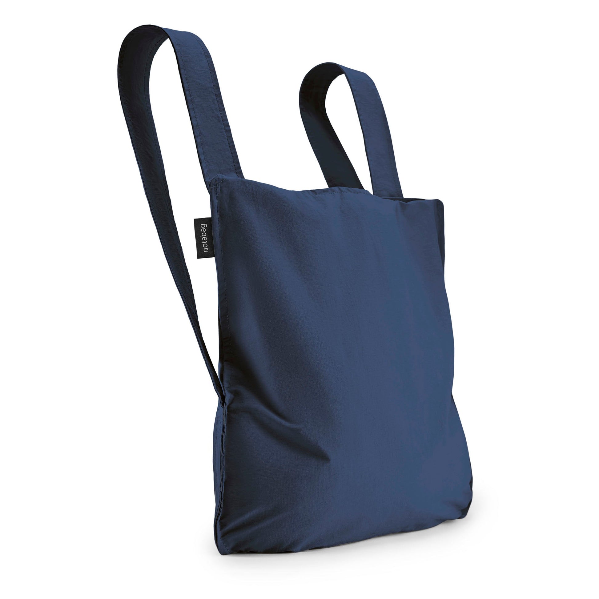Navy Blue Notabag as a backpack against a white background