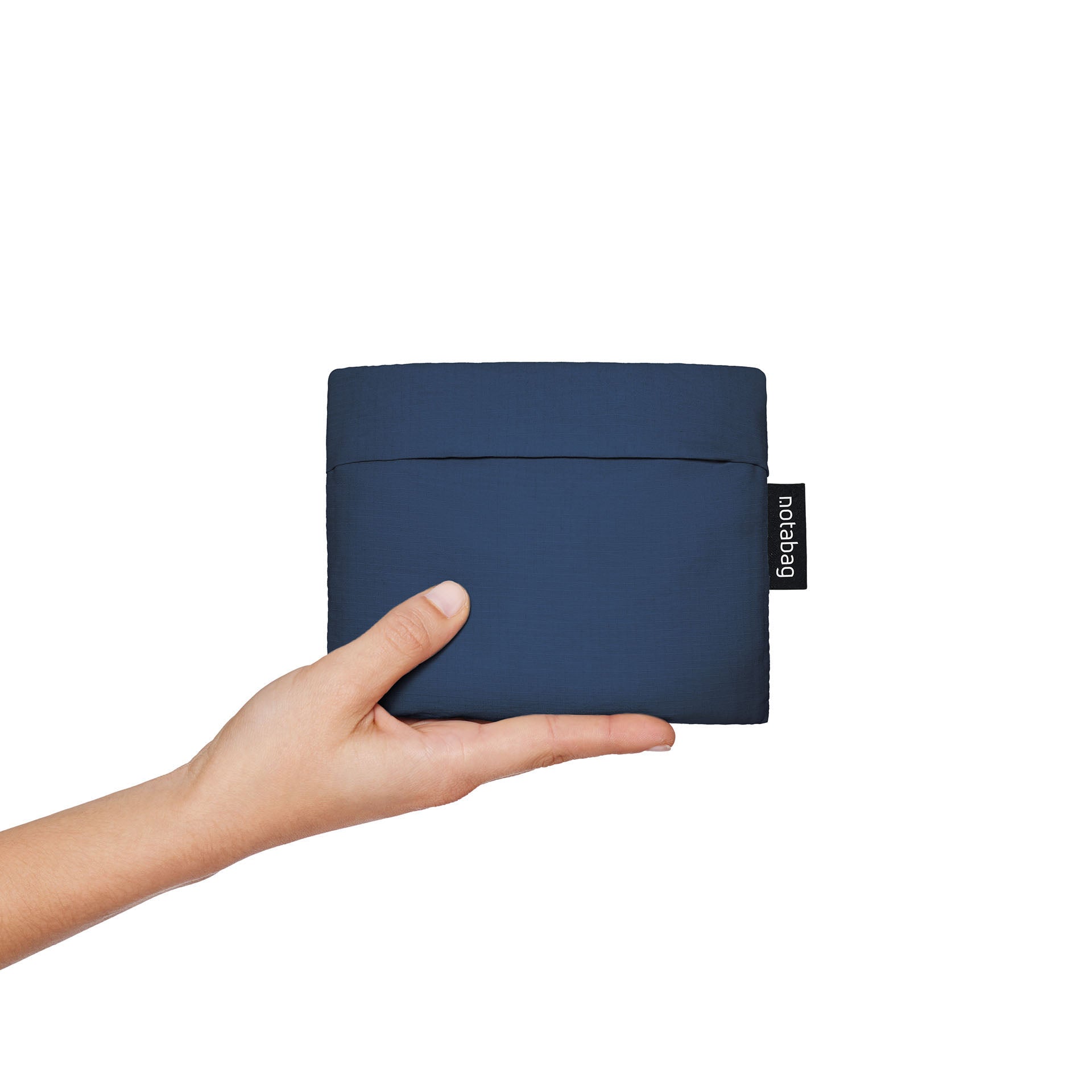 Navy blue Notabag folded up, compact size