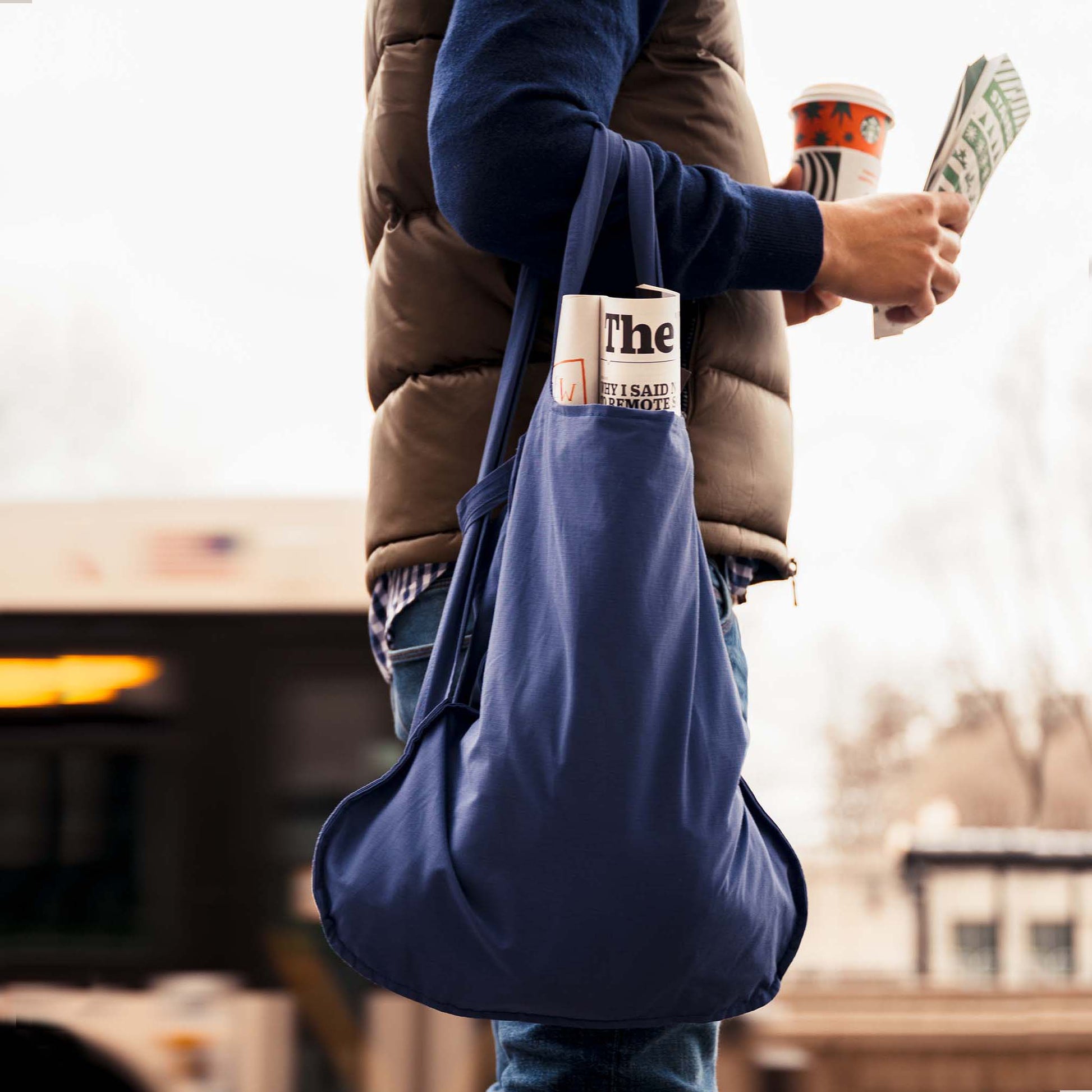 Navy blue Notabag worn over the arm