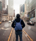 Man wears navy blue Notabag backpack on the street