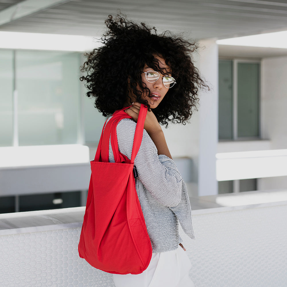 Red Notabag as a shopper bag against a white background