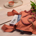 Notabag Terracotta shopper bag with books on a wooden table