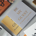 Gastenboek Geel-Beige│Printworks│art. PW00322│guestbook half in hoes tussen andere boeken