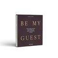 White Be My Guest guest book by Printworks standing upright, seen at an angle from the front
