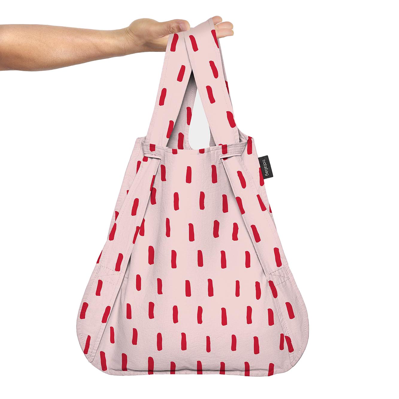 Notabag Red Brush as a shopper bag held in the hand