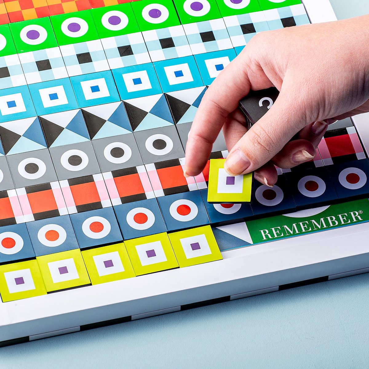 Remember Sudoku Wooden Board Game | a hand placing a loose tile in a row