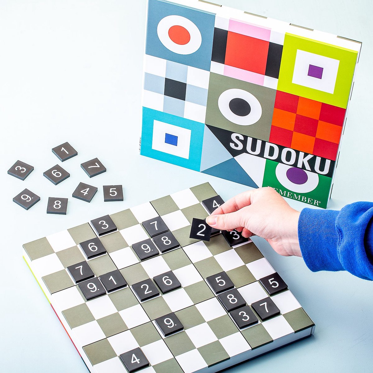 Remember Sudoku Wooden Board Game | a hand placing a tile on the board