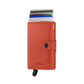 Secrid Miniwallet Original│Pasjeshouder en Portemonnee│art. M-ORANGE│voorkant met uitgeschoven pasjes en clip