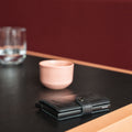 Secrid Miniwallet Vintage Zwart│art. MV-BLACK│Pasjeshouder en Portemonnee│zijaanzicht op tafel naast koffiekop