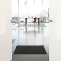 Chilewich Shag Deurmat 46x71 Skinny Stripe Steel│art. 200134-008│in deuropening op betonnen vloer van luxe appartement