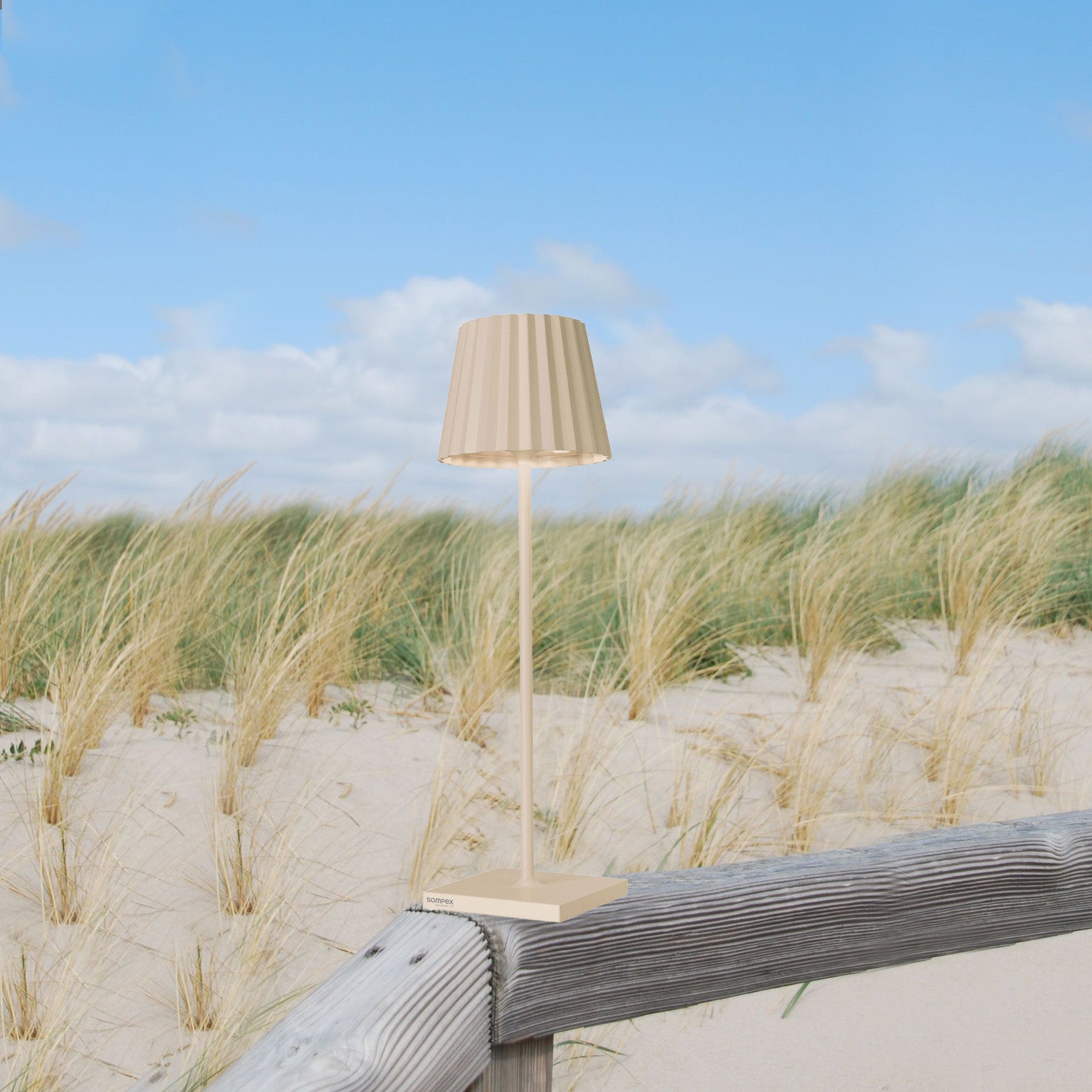 Sompex Troll 2.0 Sand│Oplaadbare Tafellamp│Buitenverlichting│art. 78184│op houten hek in duinen