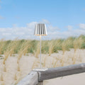 Sompex Troll 2.0 Zilver│Oplaadbare Tafellamp│Buitenverlichting│art. 78186│op houten hek in duinen