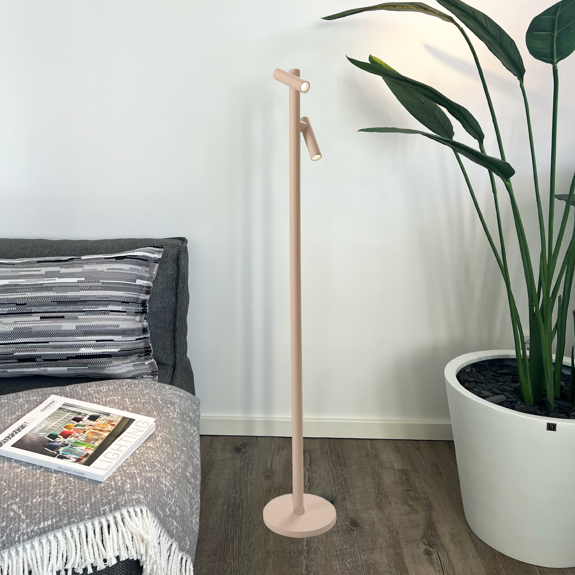 Sompex Tubo Oplaadbare Vloerlamp Dubbel Sand staat op houten vloer naast grijze bank