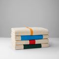 Strandlaken Martens & Martens Suite702│4 varianten opgevouwen op stapel met voorkant zichtbaar