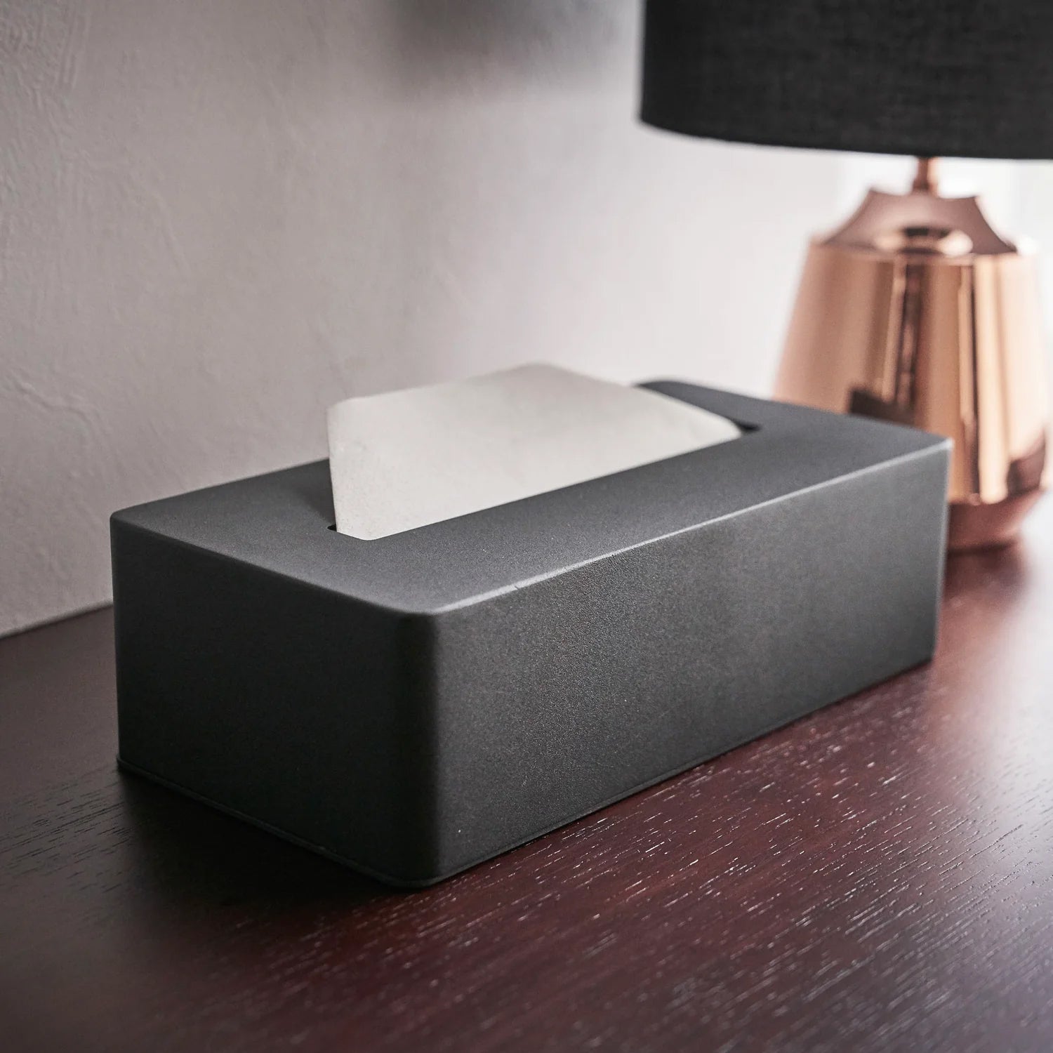 Tower Tissuebox Staal Zwart│Yamazaki│art. 04216│close-up op houten tafel naast lamp