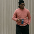 Man met golfwand op achtergrond houdt Dopper Travel Mug Small 300ml Breaker Blue (blauw) in hand