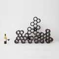 Wijnrek Grape│Robert Bronwasser│Goods│drie Grapes gestapeld naast wijnglas