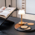 Humble Two Oplaadbare tafellamp Gold Frosted│Draadloos│art. HUMTL00204│in interieer op zwarte houten eettafel